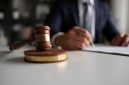 Judge or Legal advisor lawyer examining and signing legal documents.