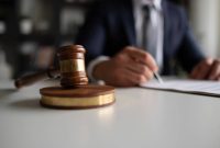 Judge or Legal advisor lawyer examining and signing legal documents.