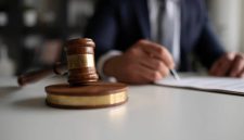 Judge or Legal advisor lawyer examining and signing legal documents.